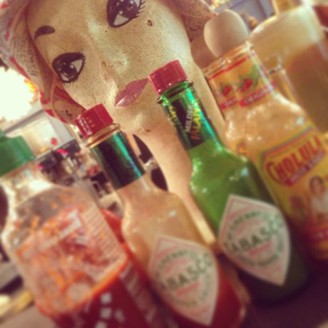 closeup of multiple hot sauces